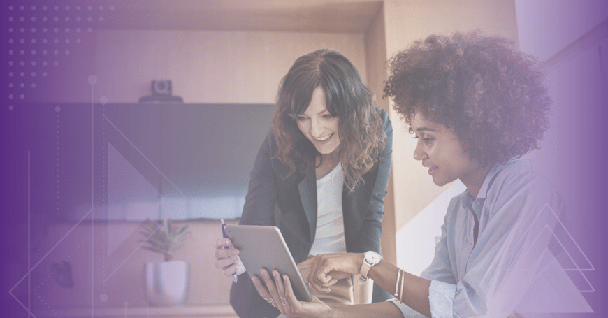  Two women at work looking at ipad 